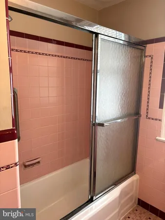 a bathroom with a shower and a tub