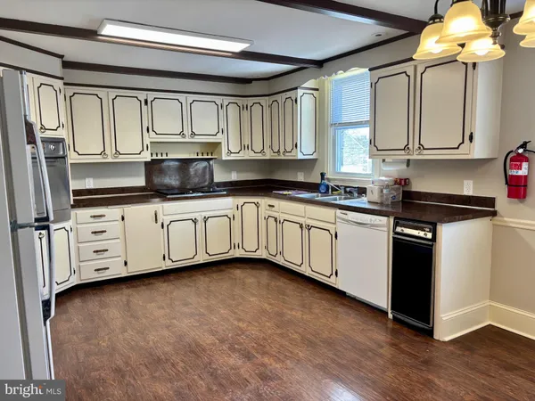 a kitchen with stainless steel appliances a sink and cabinets