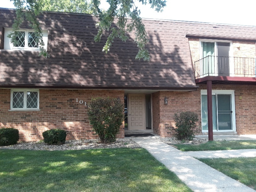 1019 Shagbark Road, Unit 1E New Lenox, IL 60451 - Photo 1 of 15 a front view of a house with a garden and plants