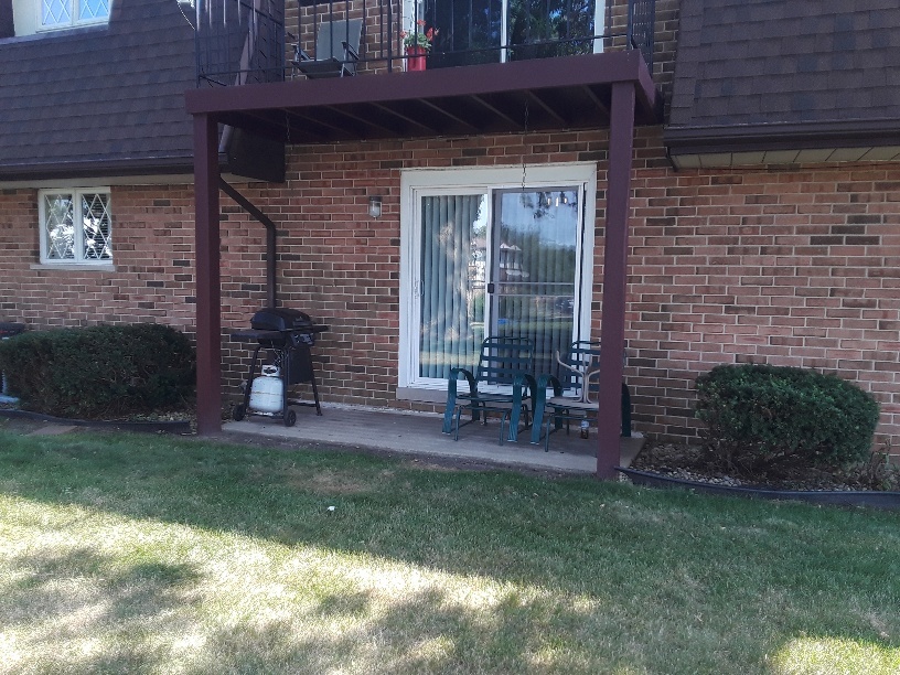 1019 Shagbark Road, Unit 1E New Lenox, IL 60451 - Photo 4 of 15 a front view of a house with a yard