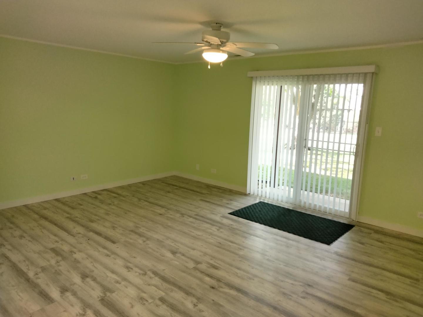 1019 Shagbark Road, Unit 1E New Lenox, IL 60451 - Photo 6 of 15 wooden floor in an empty room with a window