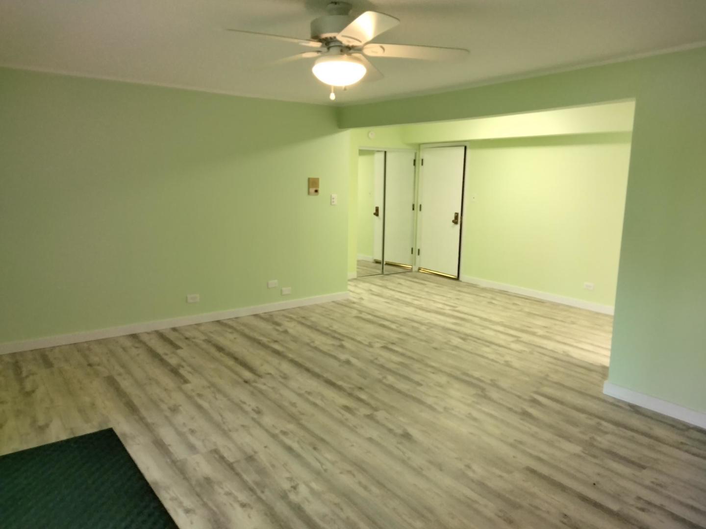 1019 Shagbark Road, Unit 1E New Lenox, IL 60451 - Photo 7 of 15 a view of an empty room with wooden floor