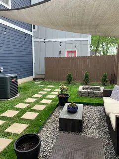 a view of a backyard with plants and a garden
