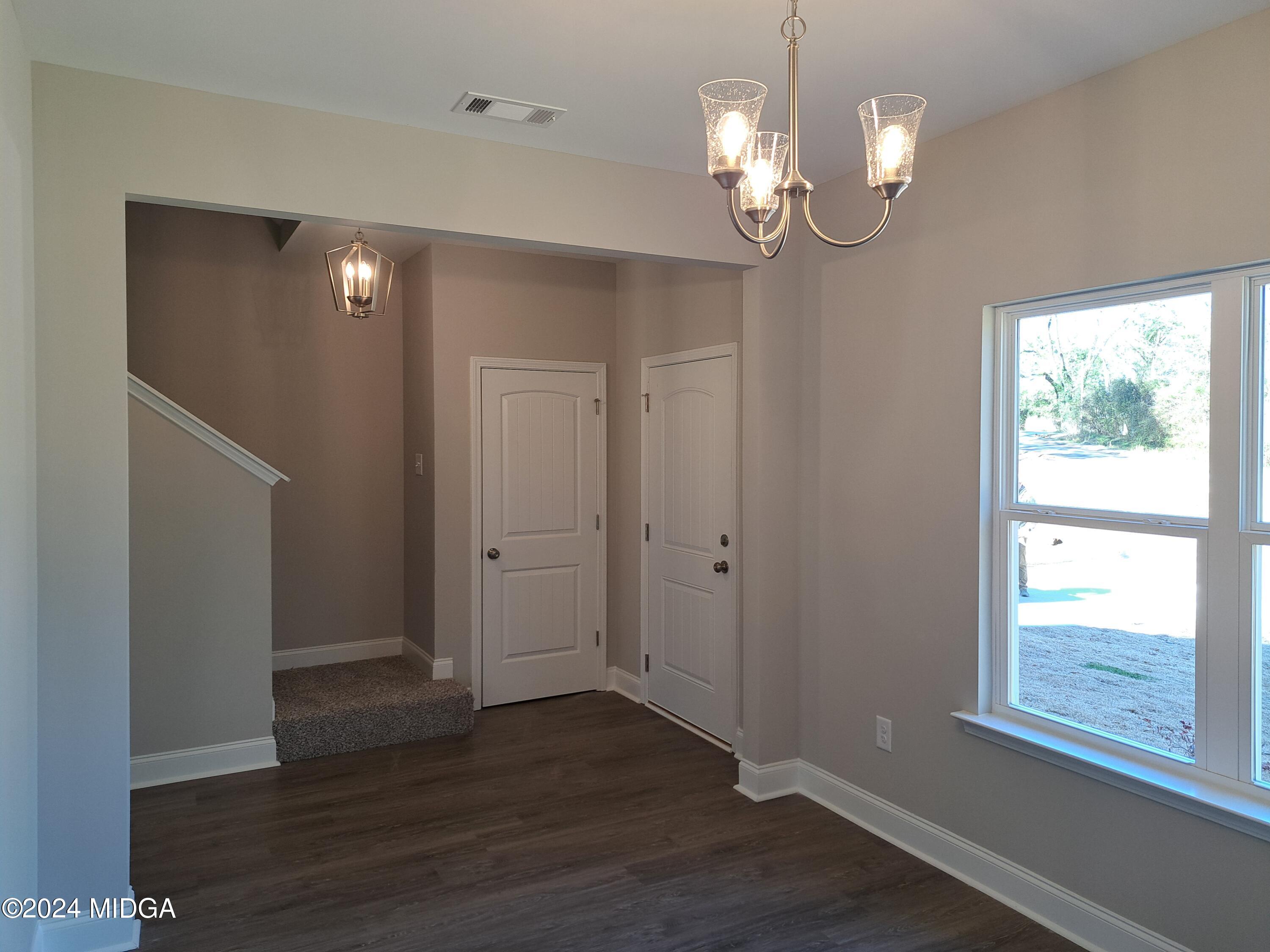 368 Walnut Grove Road Gray, GA 31032 - Photo 4 of 32 a view of empty room with wooden floor and fan