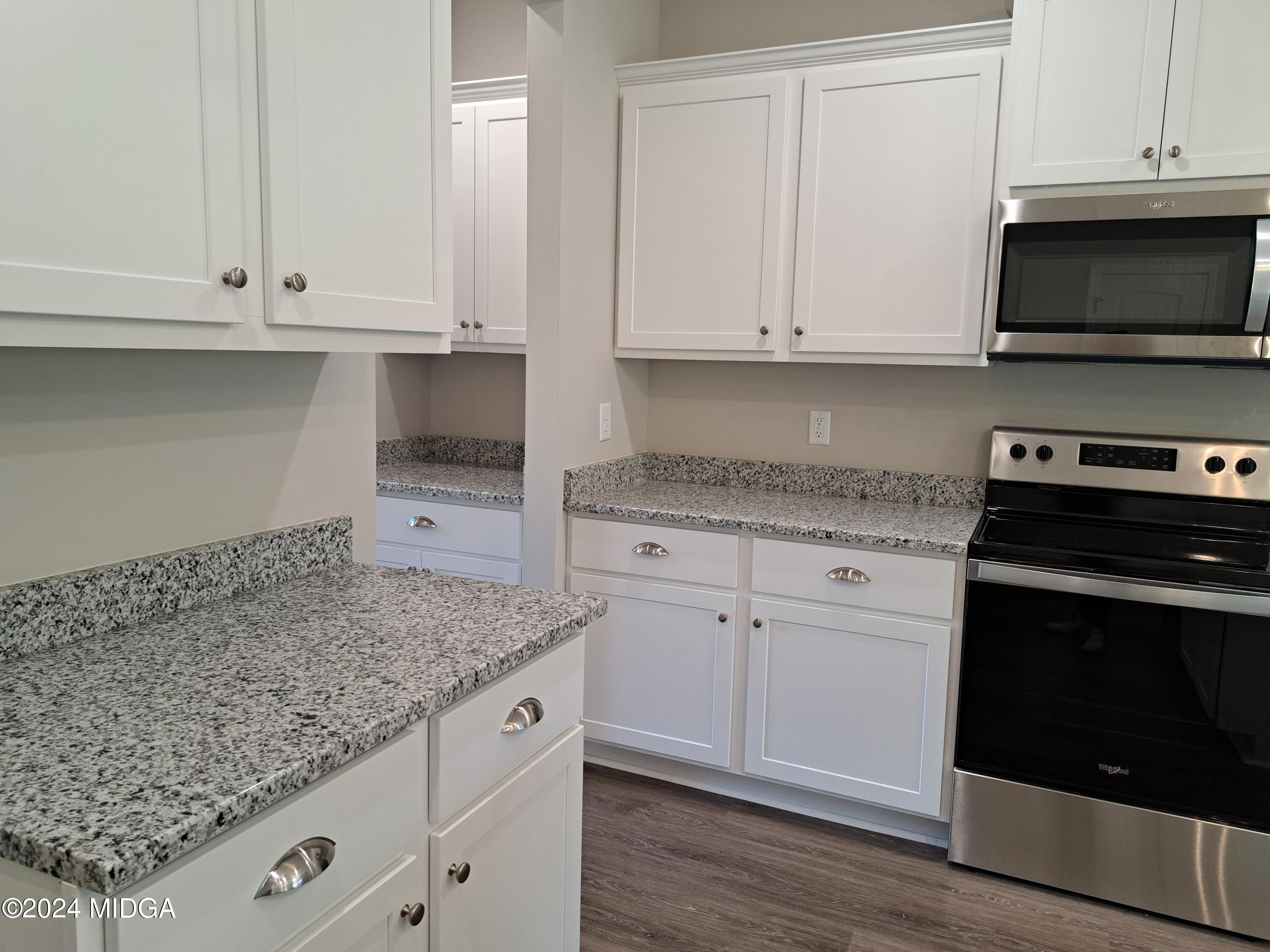 368 Walnut Grove Road Gray, GA 31032 - Photo 9 of 32 a kitchen with granite countertop white cabinets and a stove