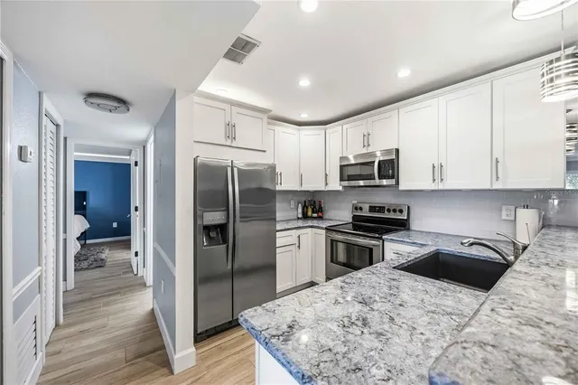 a kitchen with a stove and a refrigerator