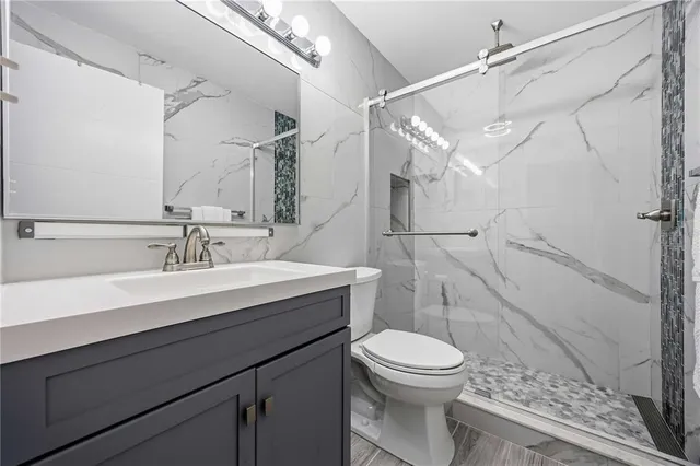 a bathroom with a toilet sink and mirror