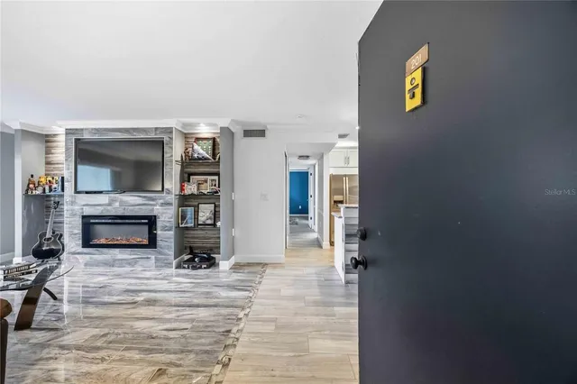 a living room with furniture and a fireplace