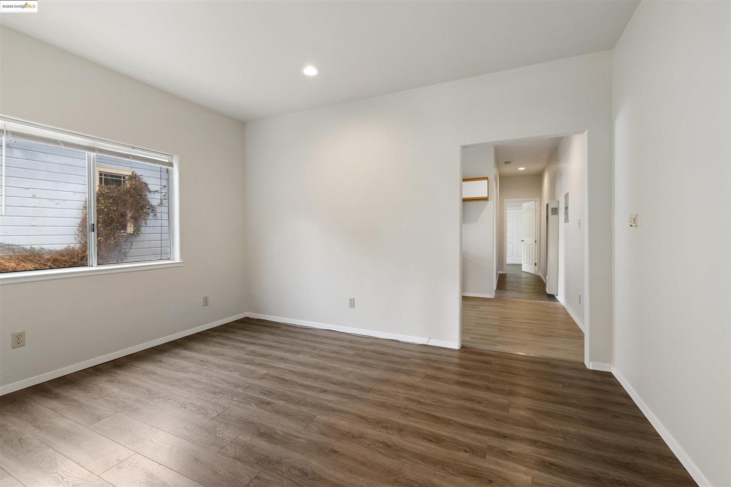 1619 Fairview Street, Unit 2 Berkeley, CA 94703 - Photo 3 of 6 a view of an empty room with wooden floor and a window