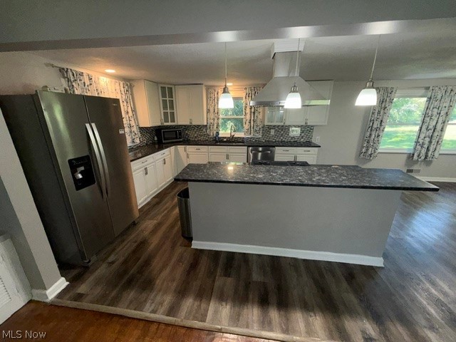 1087 Krumroy Road Akron, OH 44306 - Photo 8 of 38 Modern kitchen featuring white cabinetry, dark speckled countertops, a tile backsplash, and a central island