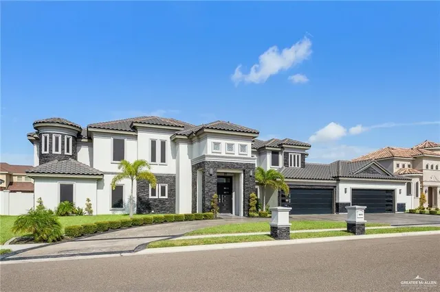 a front view of a house with a garden and plants