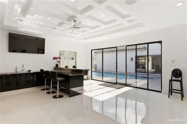 a living room with stainless steel appliances kitchen island granite countertop furniture a flat screen tv and kitchen view