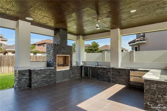 a large kitchen with kitchen island a counter space a sink and appliances