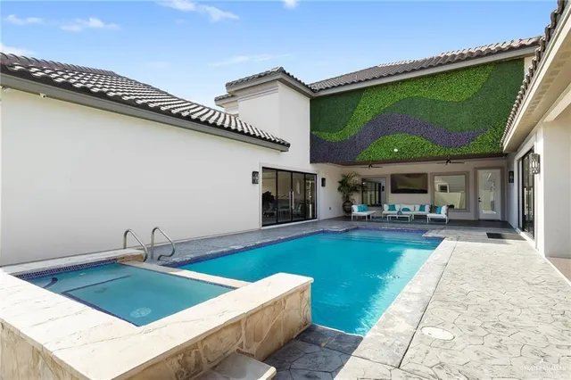 a swimming pool with yard in front of it