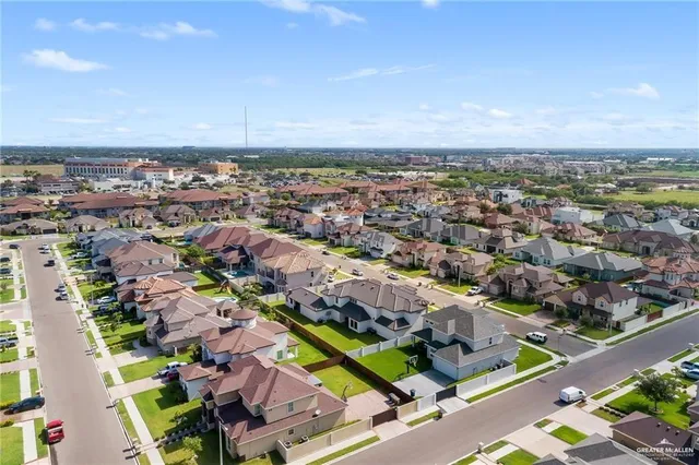 an aerial view of a house with a garden and pool