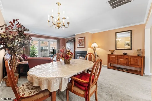 a view of a dining room with furniture and chandelier
