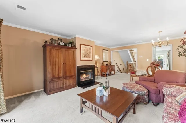 a living room with furniture a fireplace and a table