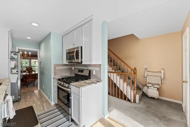 a kitchen with stainless steel appliances a refrigerator and a stove top oven