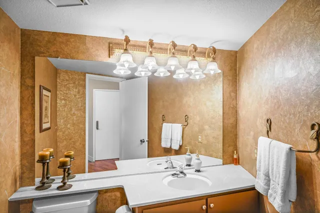 a bathroom with a sink a mirror and a light fixture