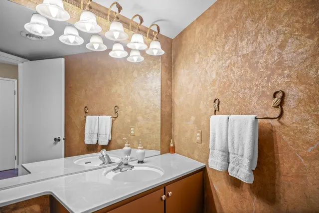 a bedroom with a bed a dresser and a window