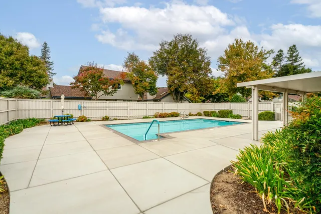 a tennis court with trees in the background