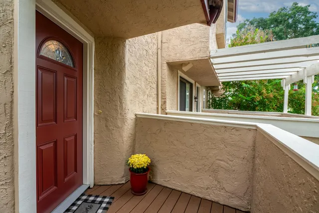 a view of a two chairs and a table in the balcony