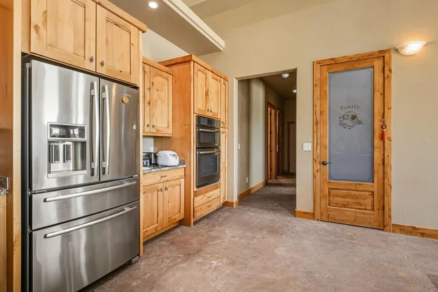 a kitchen with stainless steel appliances granite countertop a refrigerator and a sink