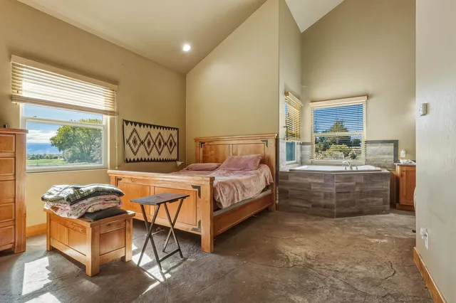 a spacious bathroom with a granite countertop tub sink and mirror
