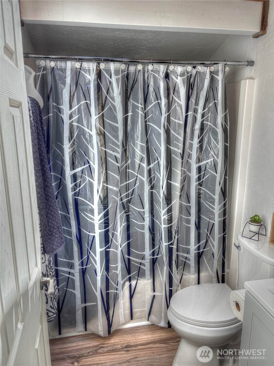 81 East Panorama Way Grapeview, WA 98546 - Photo 8 of 21 a white toilet sitting next to a shower curtain