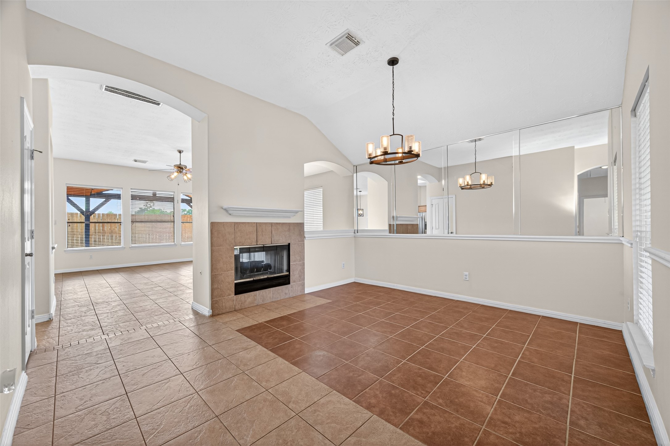 23914 Glengate Drive Spring, TX 77373 - Photo 6 of 49 a view of a livingroom with a fireplace a ceiling fan and windows