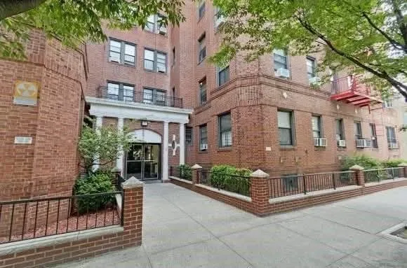 front view of a brick house with a large windows