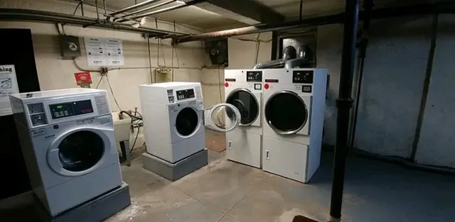 a utility room with dryer washer and a view of kitchen