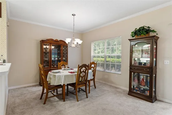 a view of a dining room with furniture and chandelier