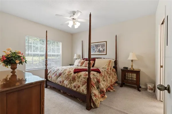 a bedroom with a large bed and a chandelier