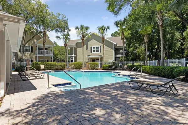 a view of swimming pool with chairs