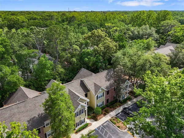 an aerial view of a house with a yard