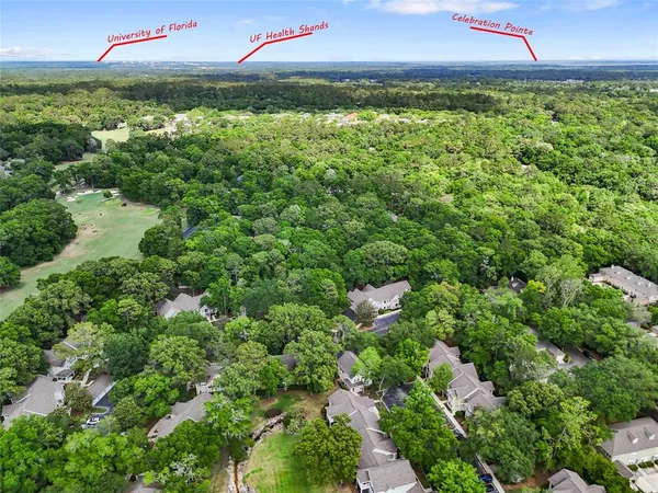 an aerial view of residential houses with outdoor and green space
