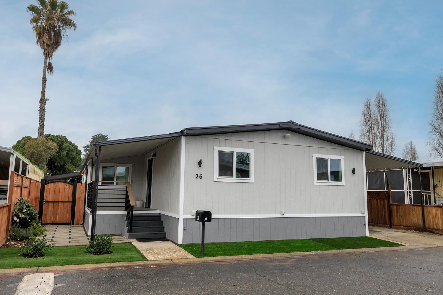 4837 Faith Home Road, Unit 26 Ceres, CA 95307 - Photo 1 of 1 a front view of a house with a yard and garage