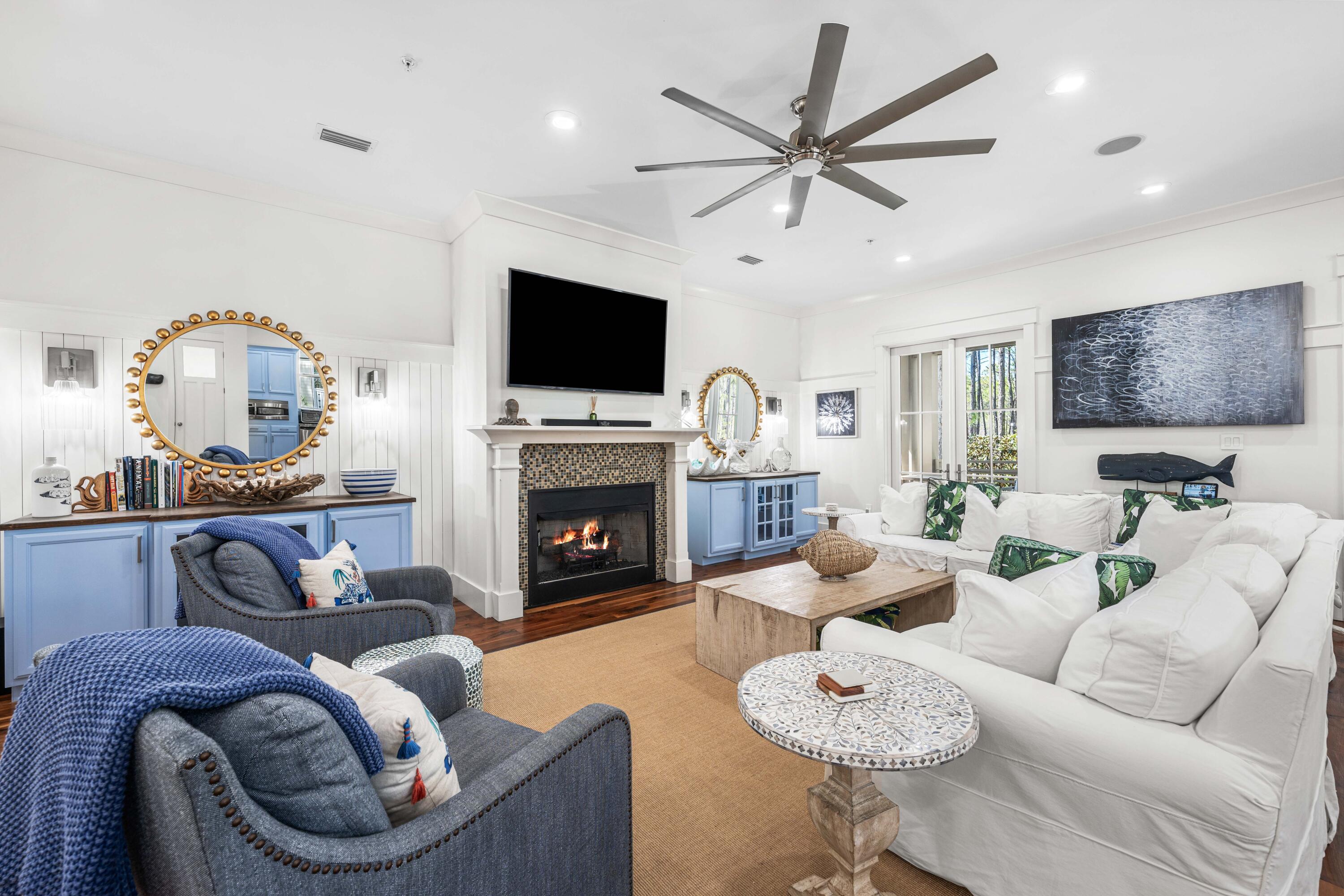 114 Pine Needle Way Santa Rosa Beach, FL 32459 - Photo 23 of 66 a living room with furniture a fireplace and a flat screen tv