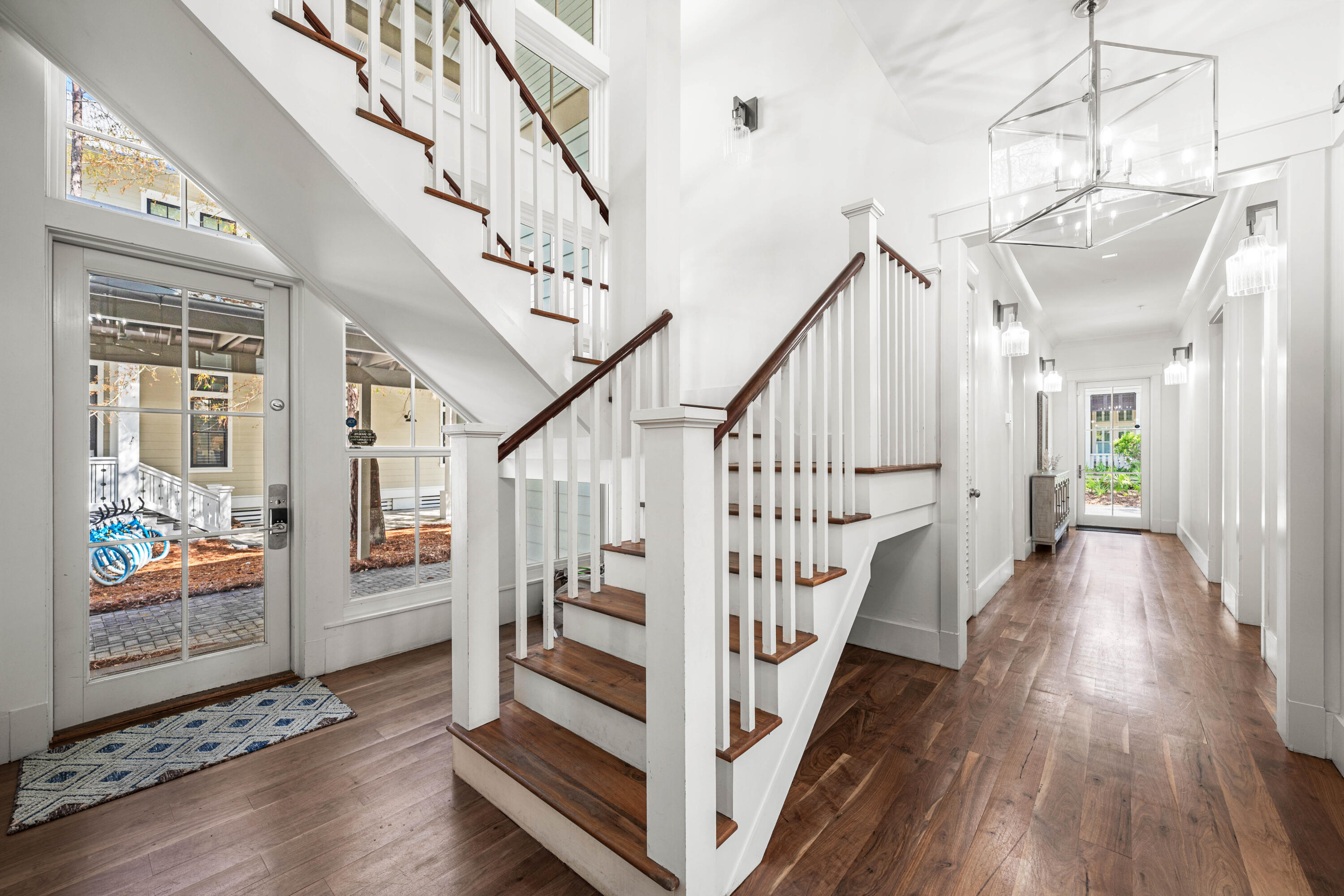 114 Pine Needle Way Santa Rosa Beach, FL 32459 - Photo 3 of 66 a view of staircase with lots of frames and wooden floor