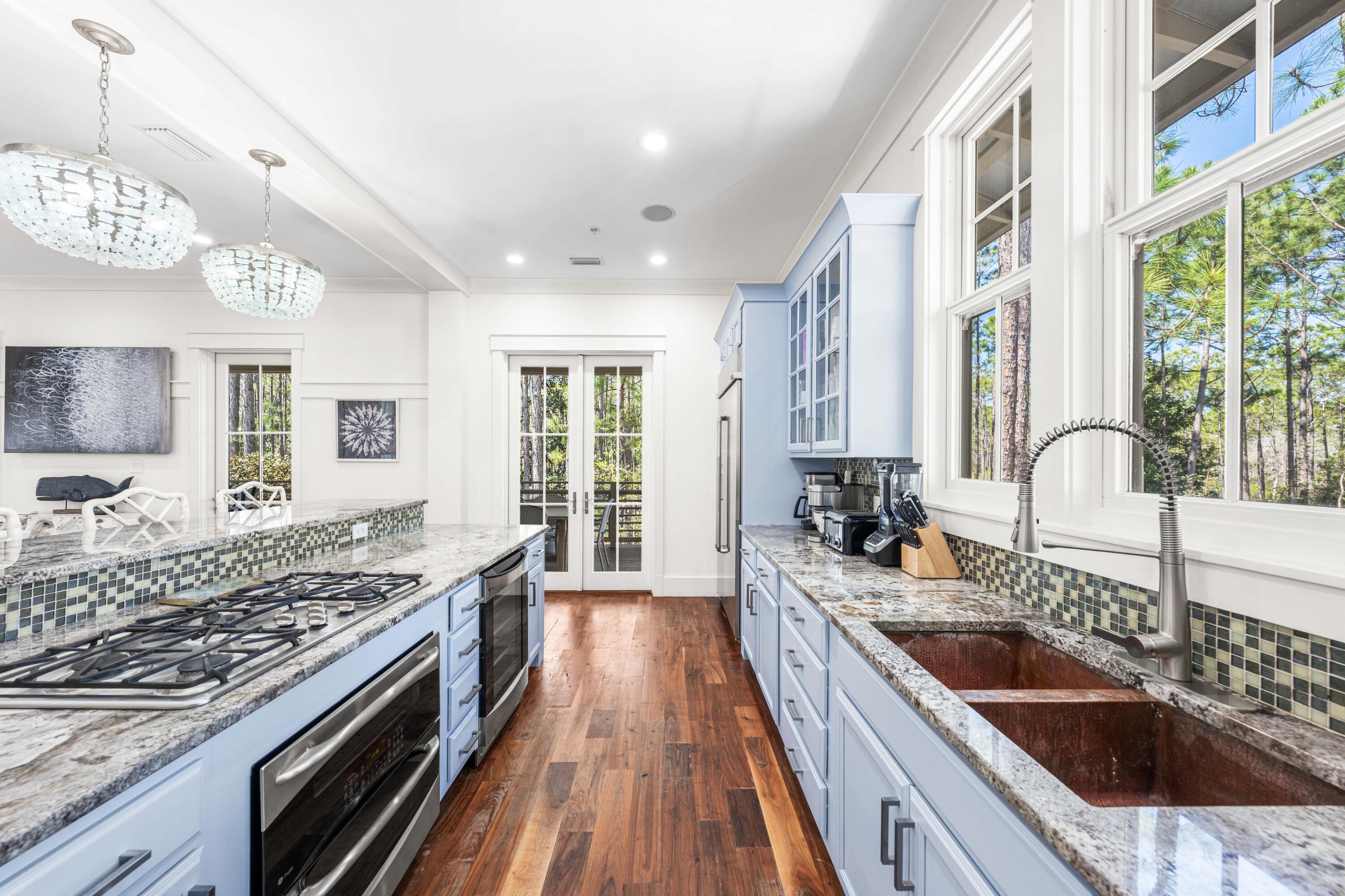 114 Pine Needle Way Santa Rosa Beach, FL 32459 - Photo 31 of 66 a kitchen with stainless steel appliances granite countertop a sink stove and refrigerator