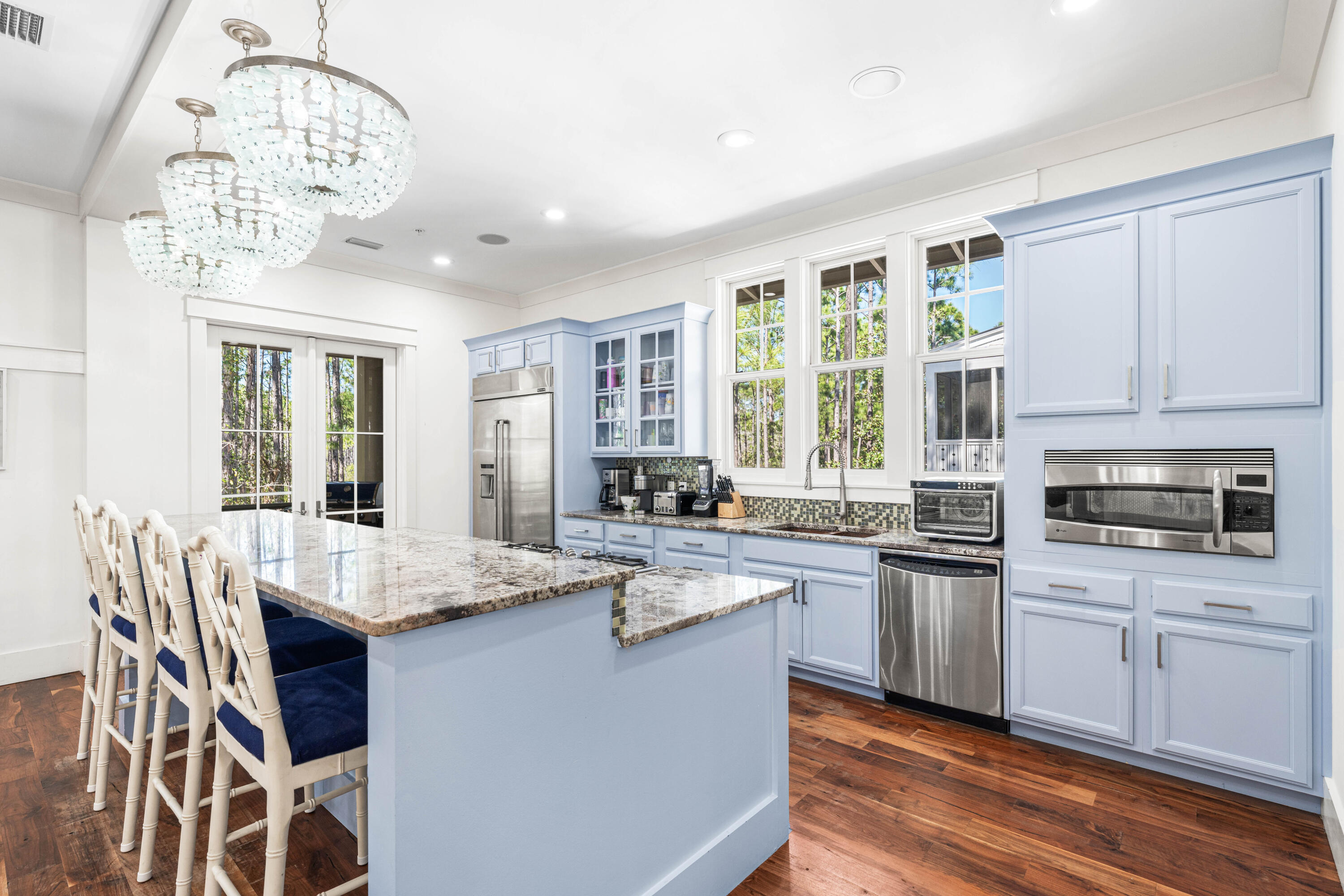 114 Pine Needle Way Santa Rosa Beach, FL 32459 - Photo 32 of 66 a kitchen with stainless steel appliances granite countertop a stove top oven a sink dishwasher and white cabinets with wooden floor