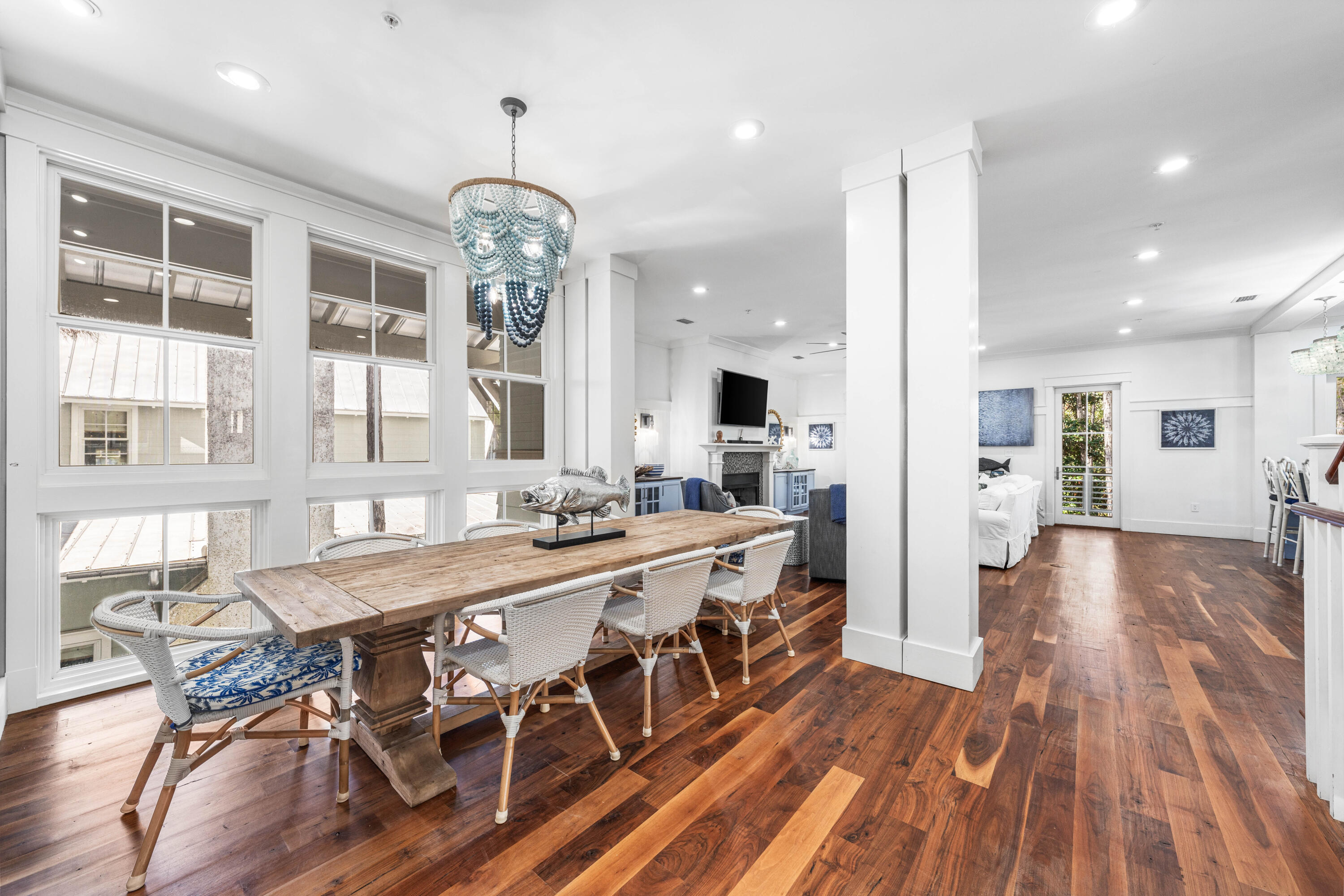 114 Pine Needle Way Santa Rosa Beach, FL 32459 - Photo 36 of 66 a large kitchen with kitchen island a large island a stove a dining table chairs and wooden floor