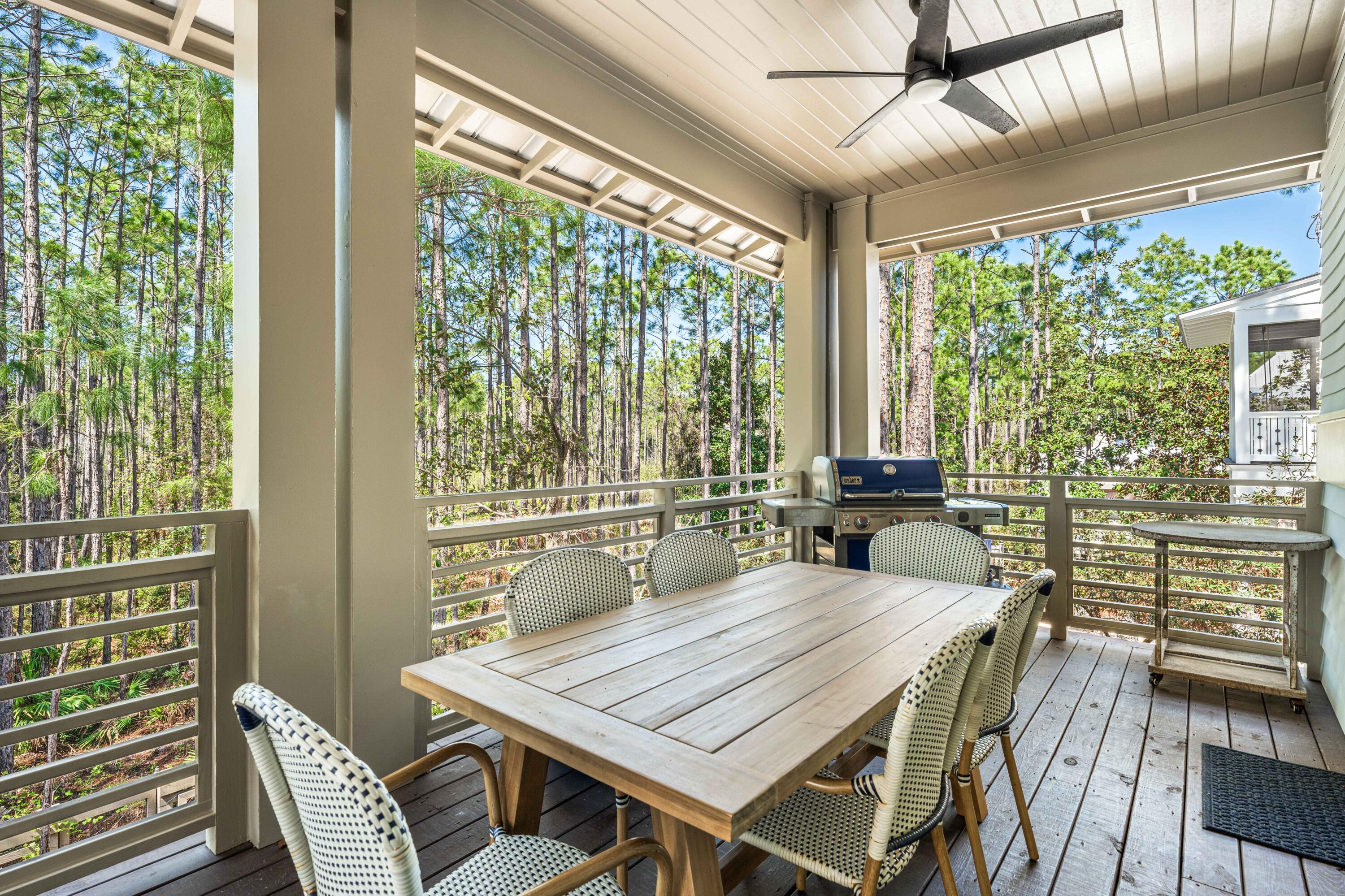 114 Pine Needle Way Santa Rosa Beach, FL 32459 - Photo 37 of 66 a dining room with furniture large windows and wooden floor