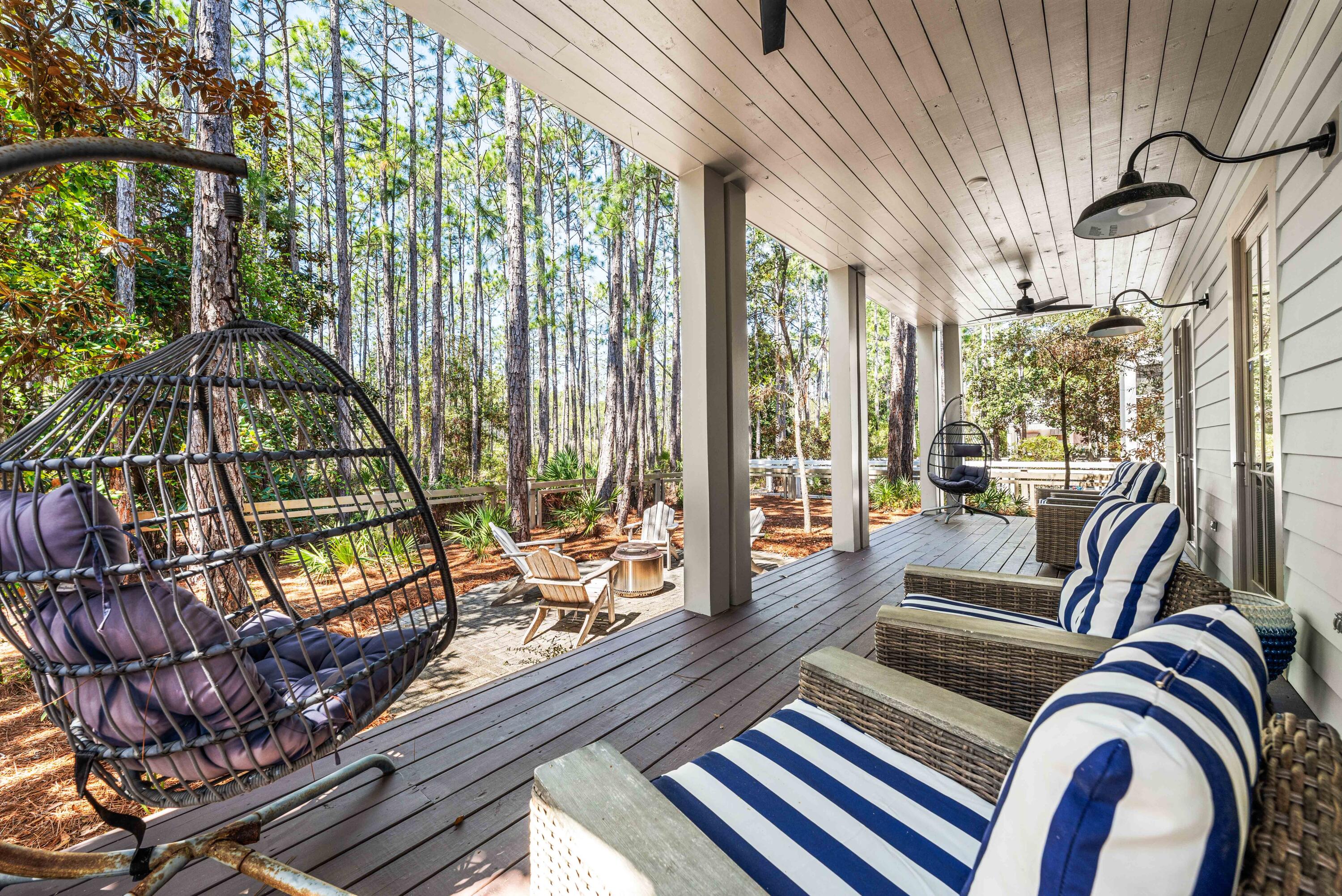 114 Pine Needle Way Santa Rosa Beach, FL 32459 - Photo 60 of 66 a living room with furniture and floor to ceiling windows