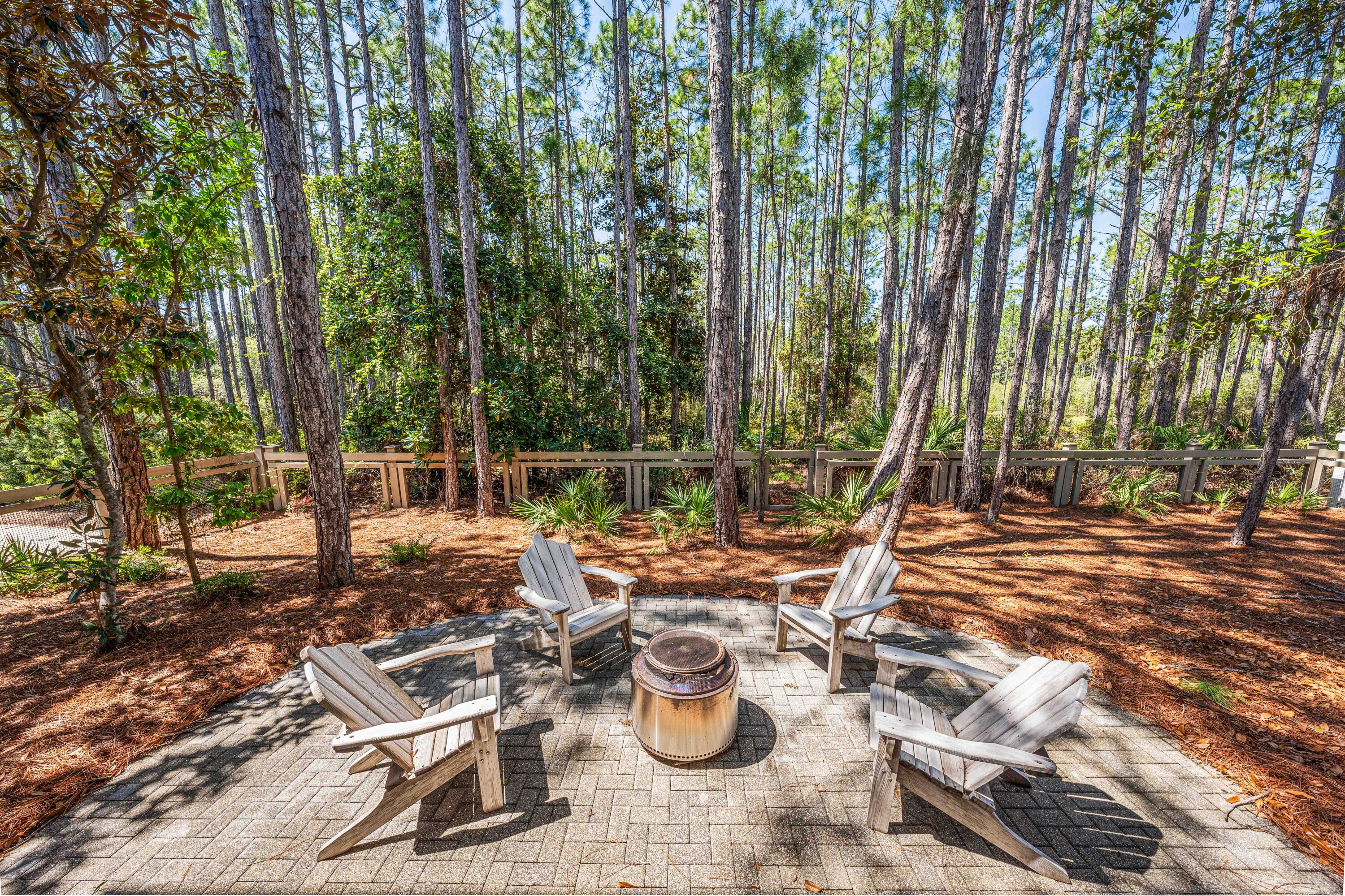 114 Pine Needle Way Santa Rosa Beach, FL 32459 - Photo 61 of 66 a view of a chairs and table in backyard