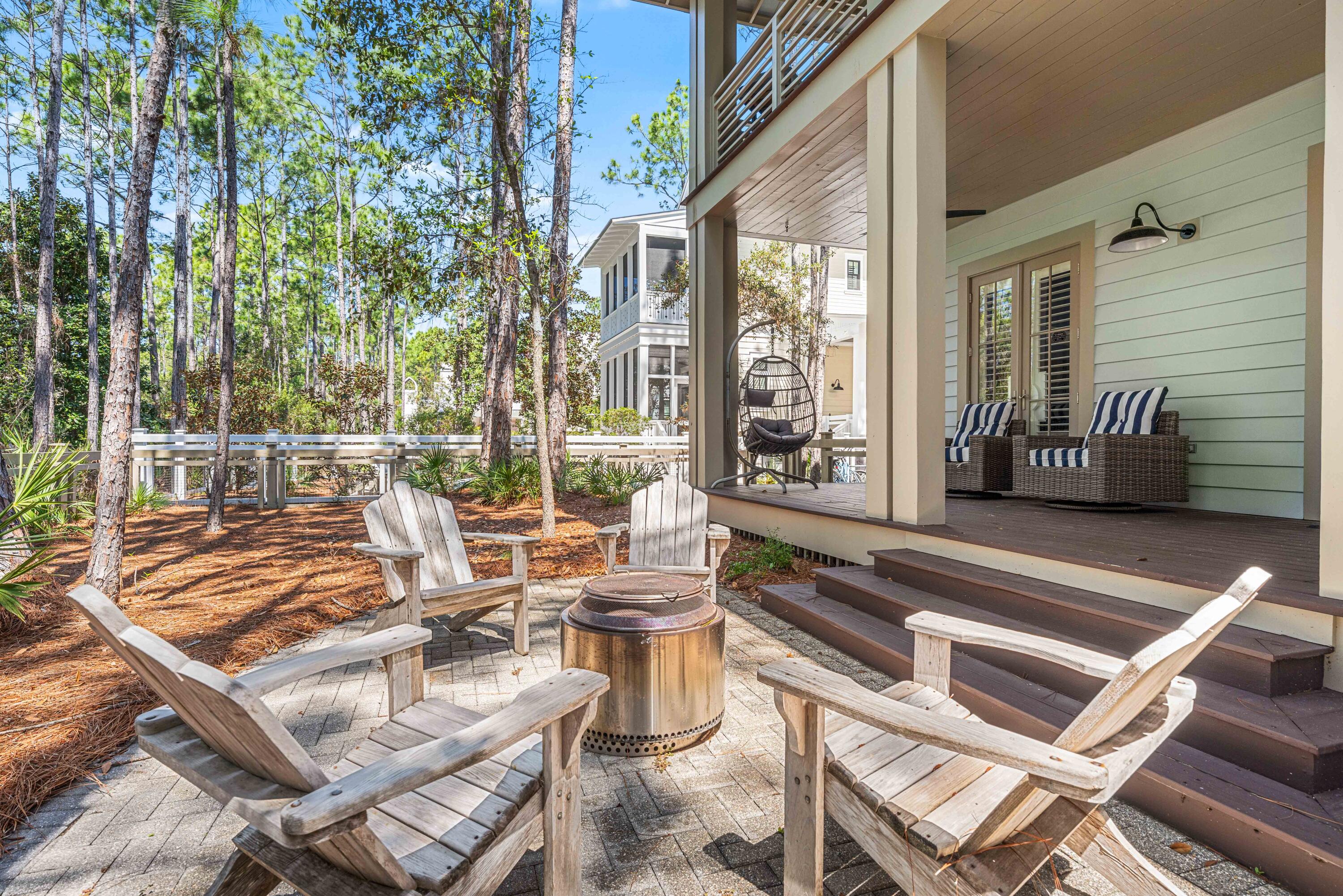 114 Pine Needle Way Santa Rosa Beach, FL 32459 - Photo 63 of 66 a view of a patio with couches table and chairs and potted plants