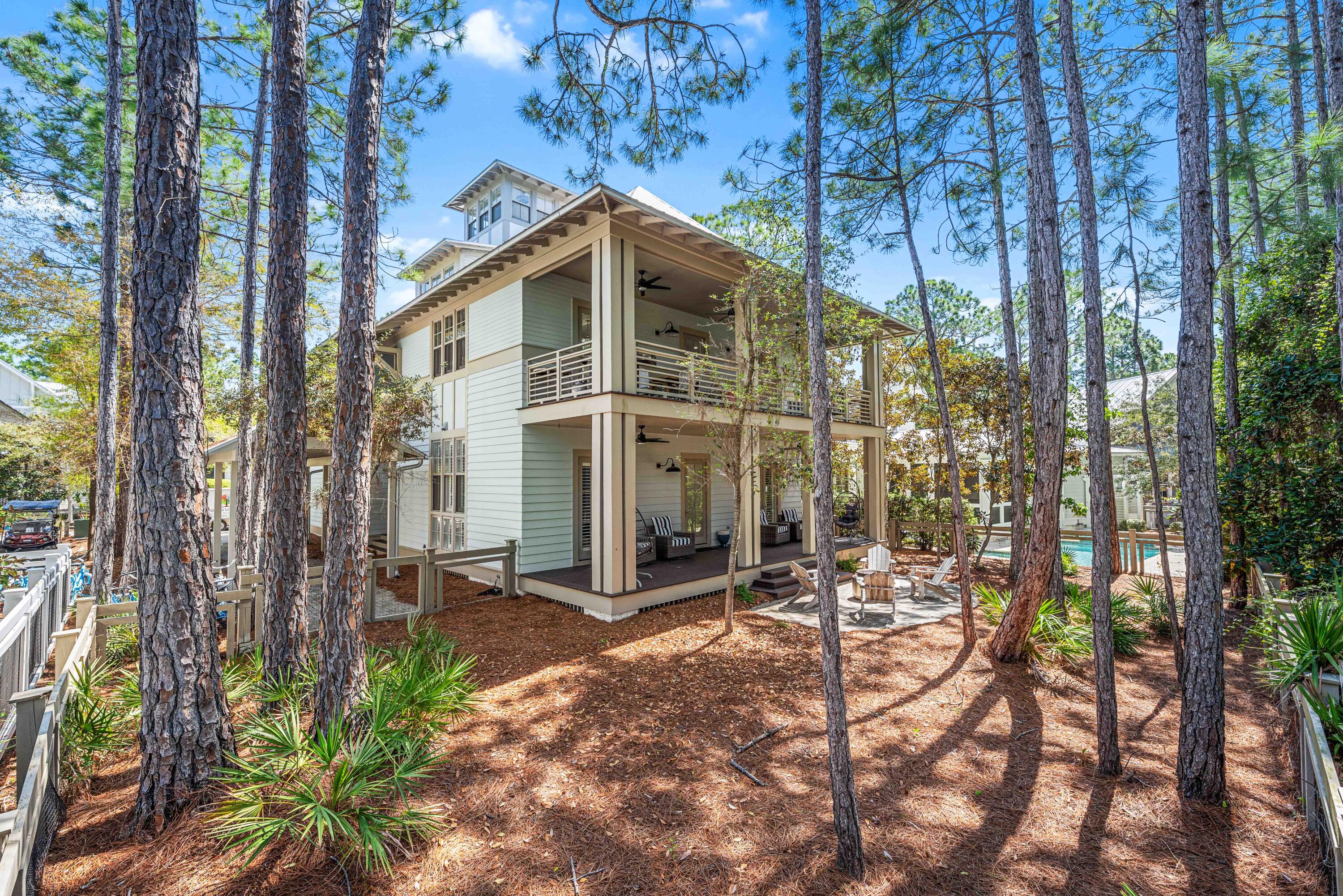 114 Pine Needle Way Santa Rosa Beach, FL 32459 - Photo 64 of 66 a view of a chair and table in backyard of the house