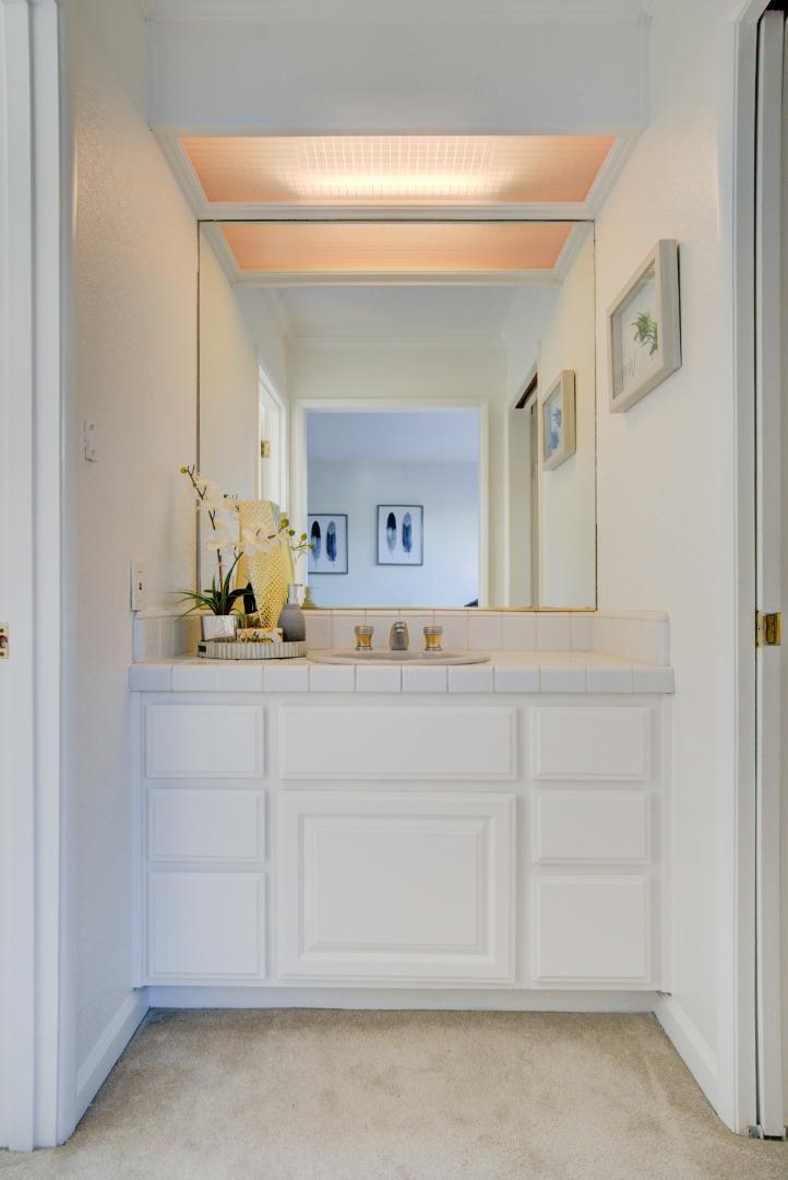 18444 Purdue Drive Saratoga, CA 95070 - Photo 16 of 31 a bathroom with a sink and a mirror