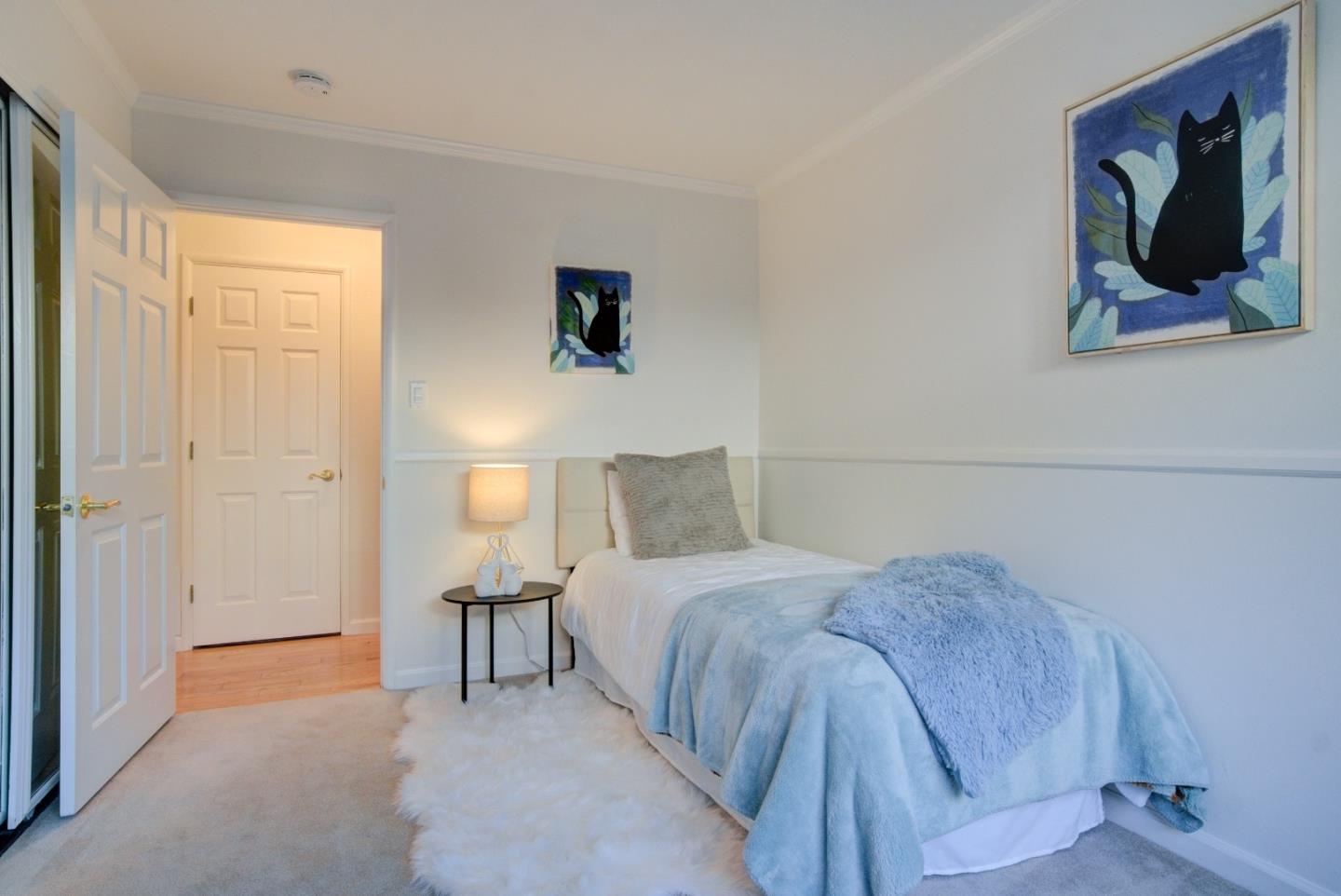 18444 Purdue Drive Saratoga, CA 95070 - Photo 19 of 31 a bedroom with a bed and a lamp